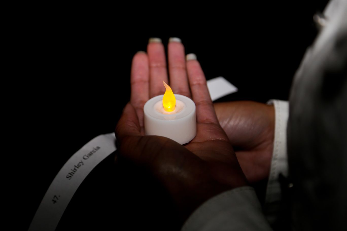 An electronic candle is held in honor of domestic violence victims during the Take Back the Night vigil in 2014.
